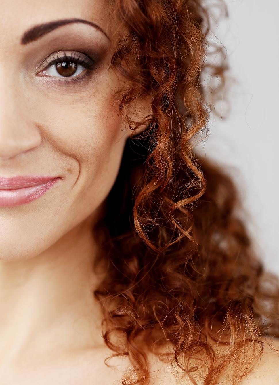 Free Image of Half face of attractive woman with curly dark hair 