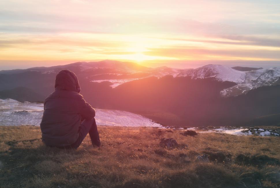 Free Image of Hiker Sitting on Top of Mountain Enjoying the Sun Rising 