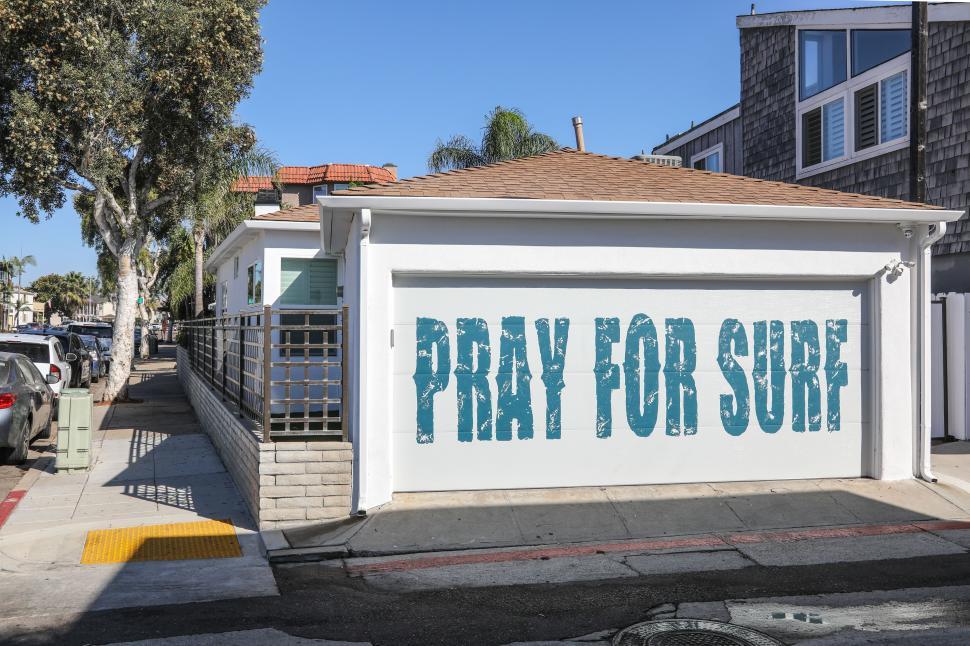 Free Image of Garage Door says PRAY FOR SURF 