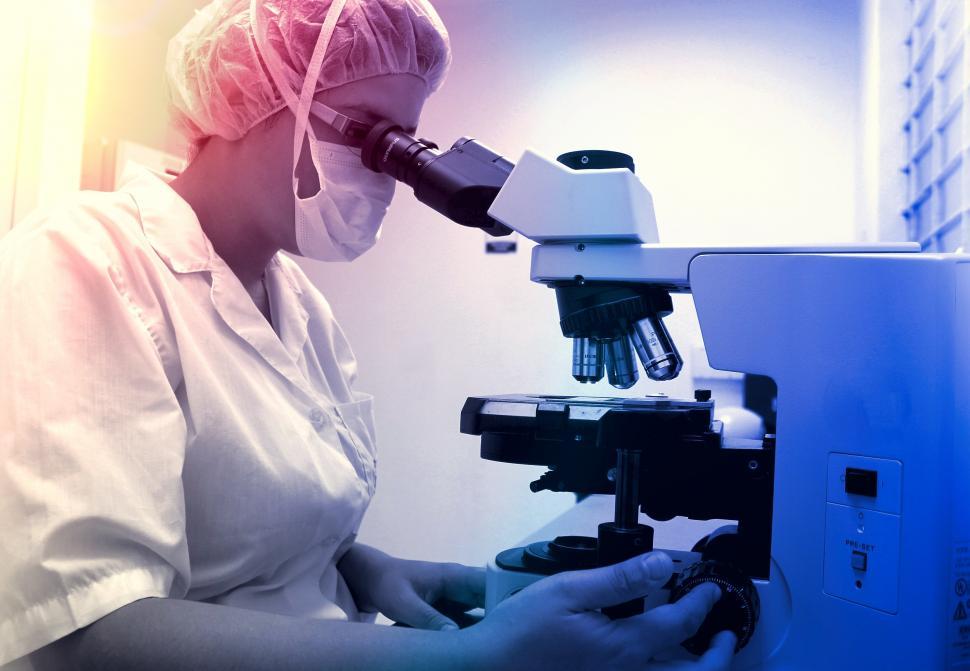 Free Image of Healthcare Professional Analyzing Samples with Microscope 