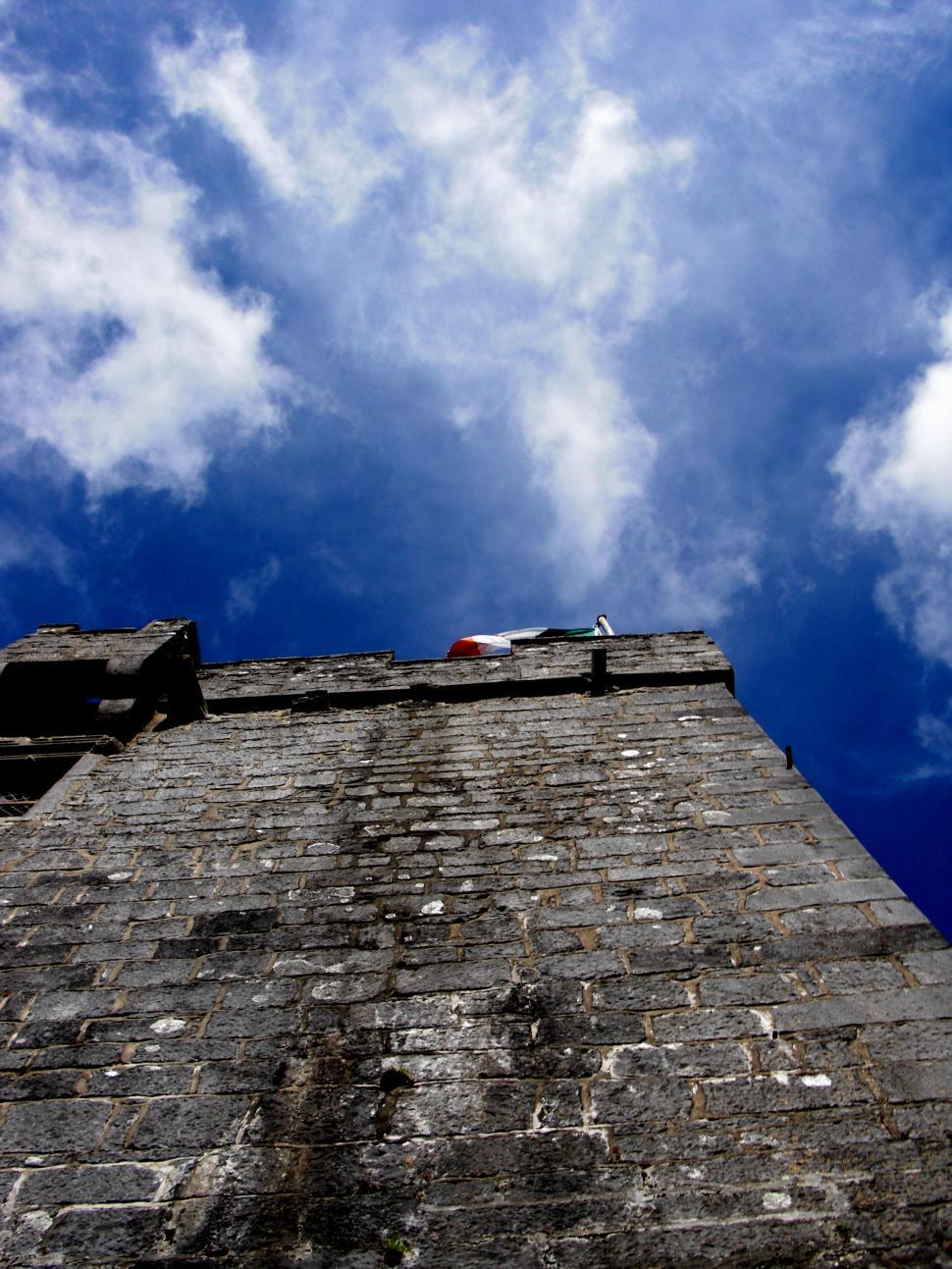 Free Image of Tall Brick Building Against Sky Background 