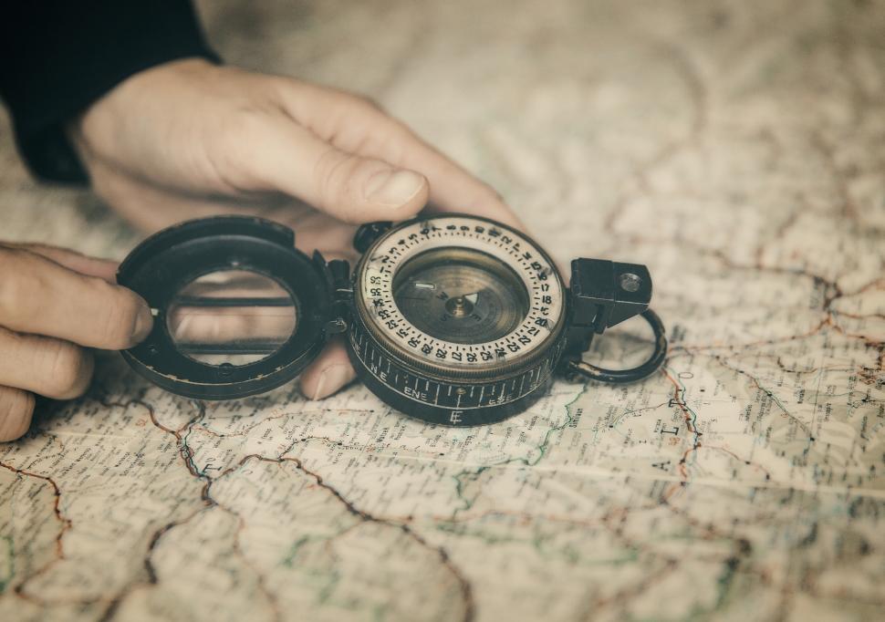 Free Image of Person Holding Compass Over Map - The Path Forward 