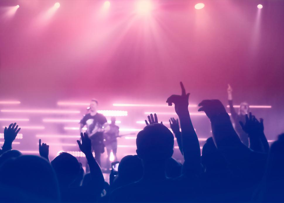 Free Image of Concert - People Silhouettes Backlit by Stage Lights 