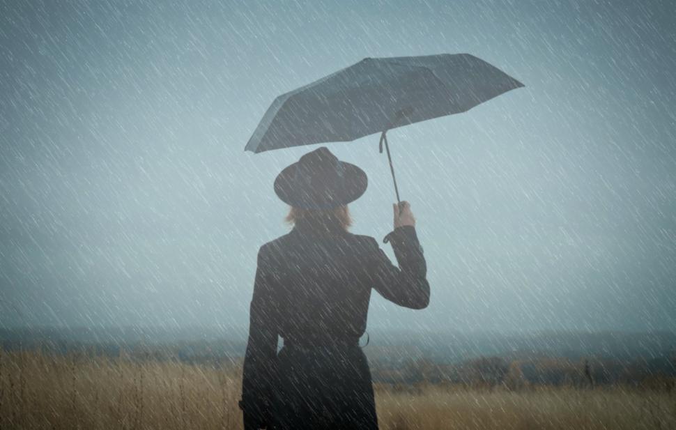 Free Image of Woman Walking Alone in the Rain - Loneliness Concept 