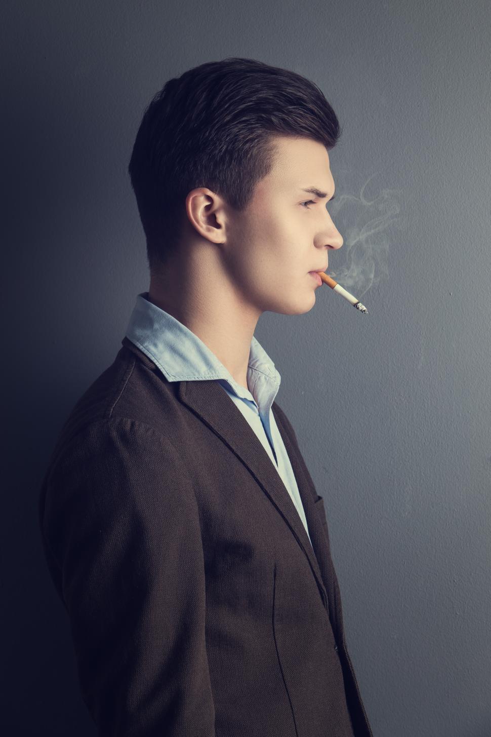 Free Image of Handsome man with cigarette dangling from lips 