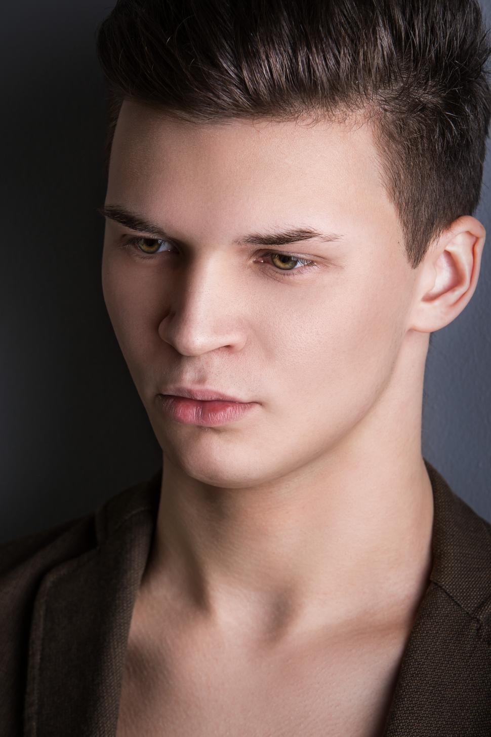 Free Image of Handsome man on dark background, three quarter profie 