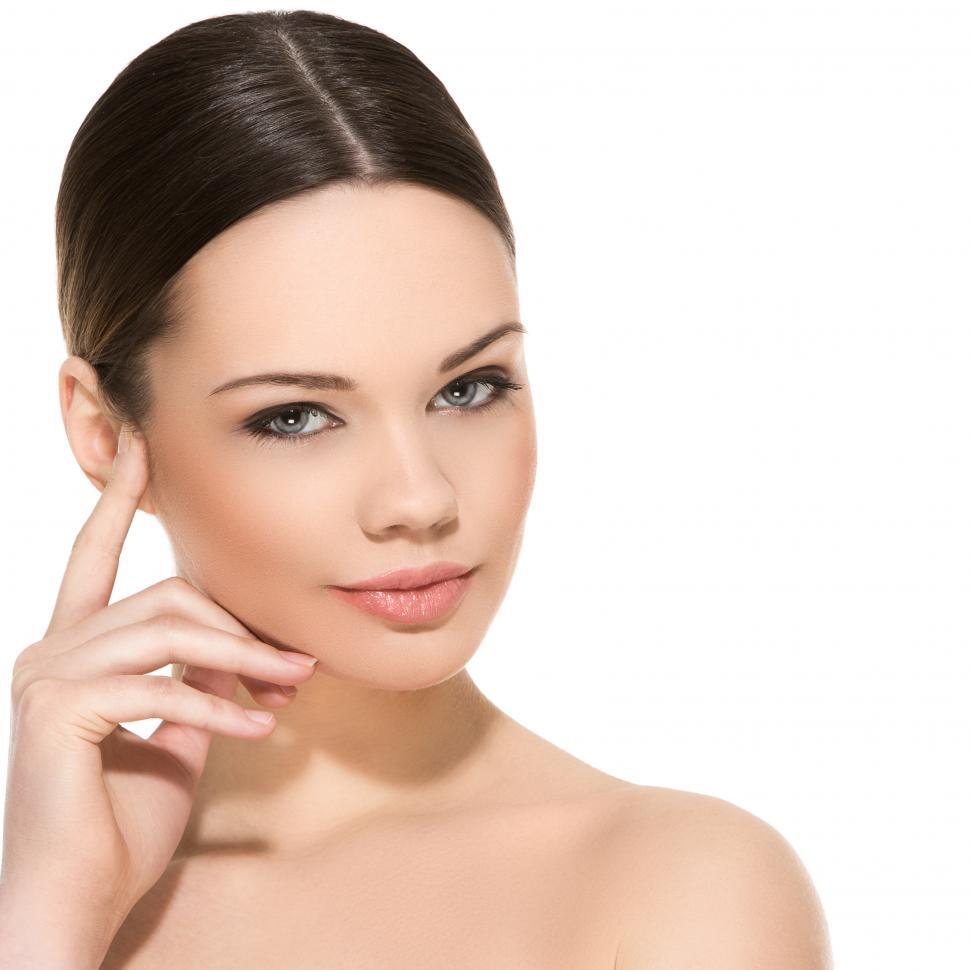 Free Image of Posed woman with hair pulled back, on a white background 
