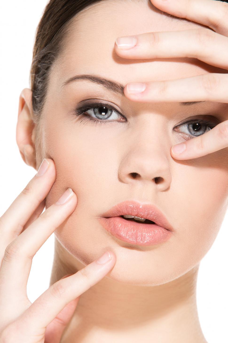 Free Image of Woman posing with hands over face, facing camera 