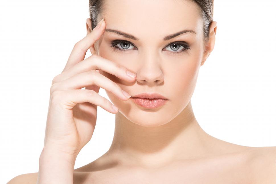 Free Image of Beautiful girl on a white background, one hand at face 