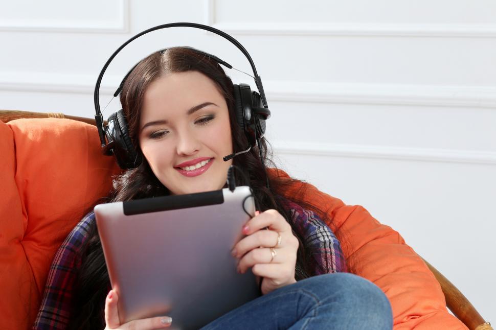 Free Image of Lifestyle. Attractive girl in comfy chair with tablet 