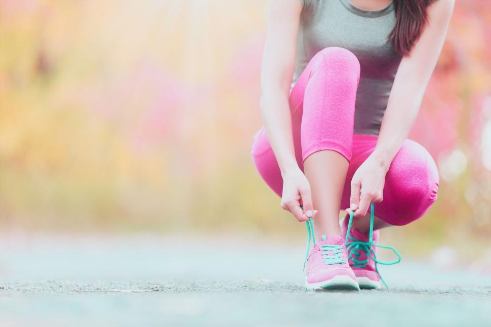 Free Image of Female Jogger Tying Shoelaces - Runner Getting Ready for Trainin 