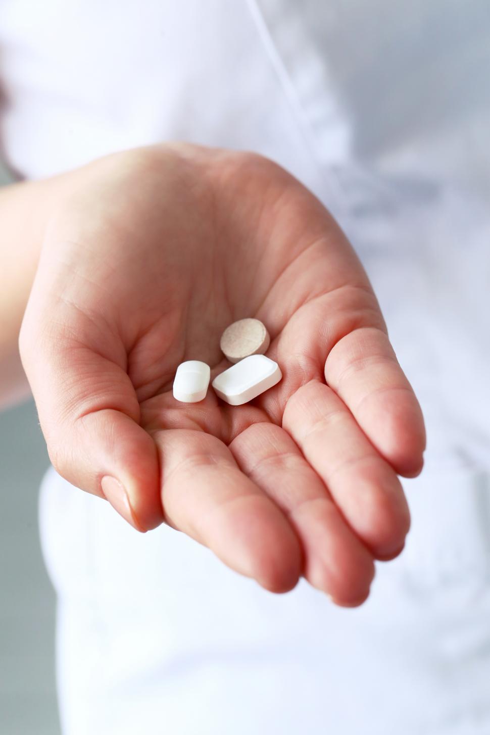 Free Image of Hand full of pills 