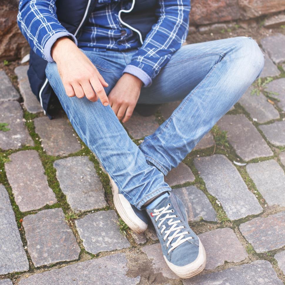 Free Image of Man outdoors, view of only hands and lower body 