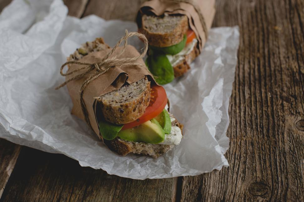 Free Image of Packaged unwrapped sandwich on the table 