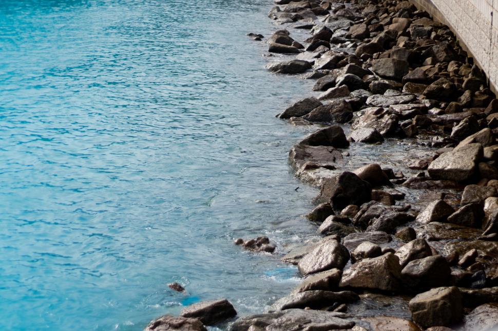 Free Image of Man Sitting on Bench by Water 