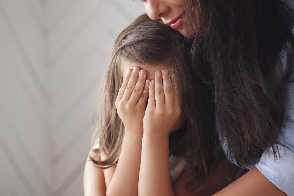 Free Image of Daughter hiding her face in her hands 