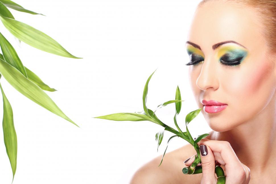 Free Image of Beautiful blonde with bamboo leaves in organic layout 