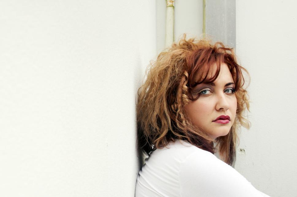 Free Image of Female fashion model face posing against white wall 
