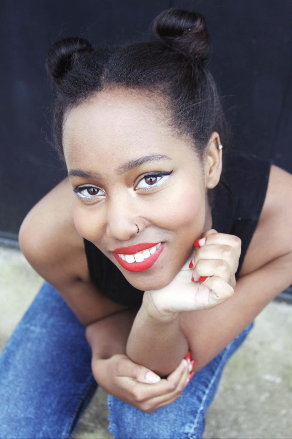 Free Image of Female fashion model with red fingernails smiling for camera 