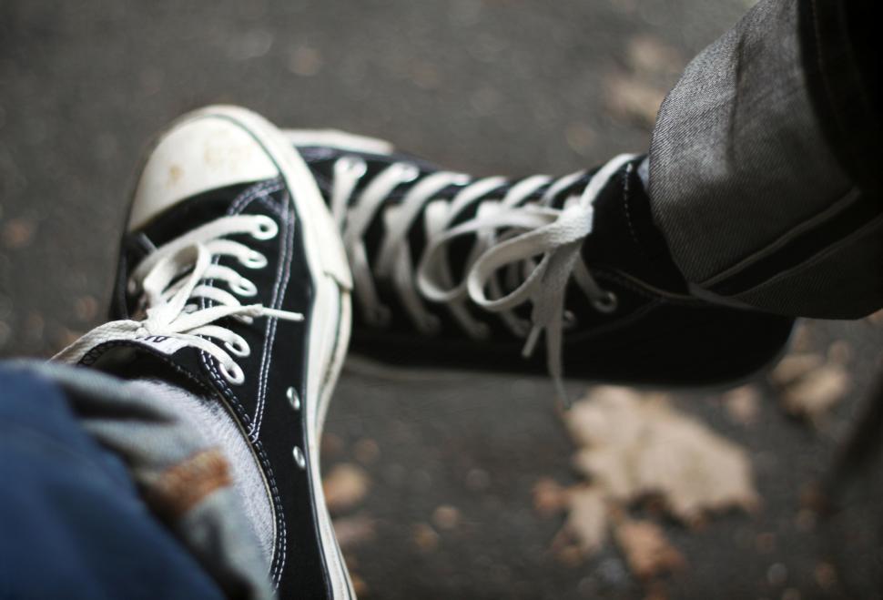 Free Image of Denim and legs with sneakers shoes 