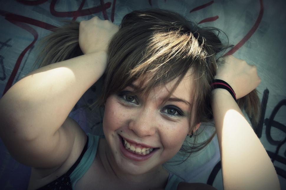 Free Image of Teenage girl with toothy smile and pigtails 