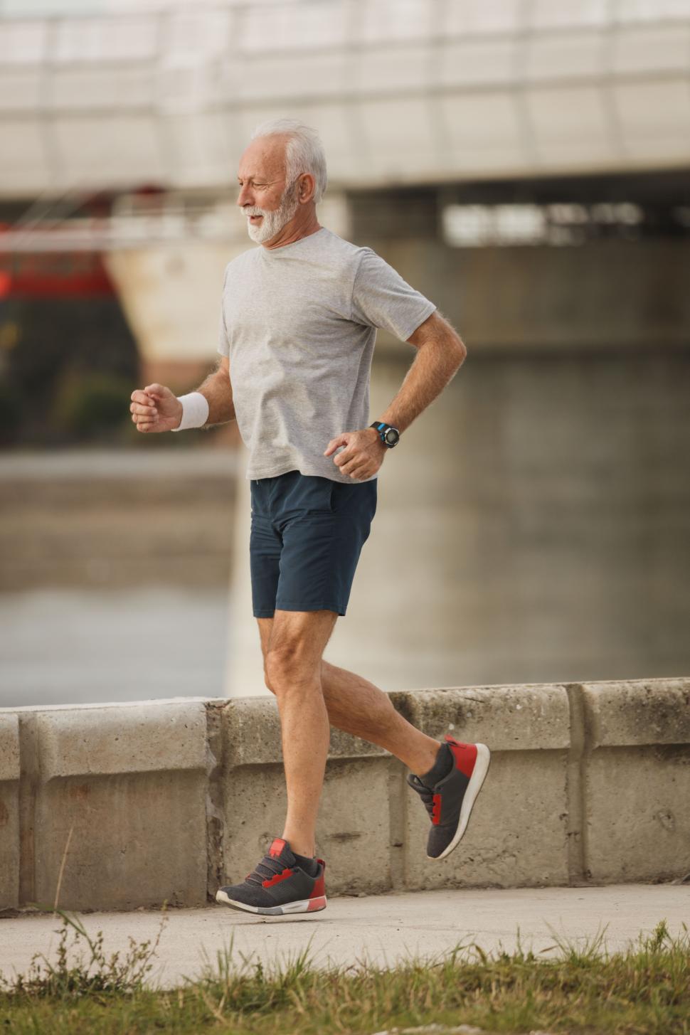 Free Image of Senior man running on the bridge 