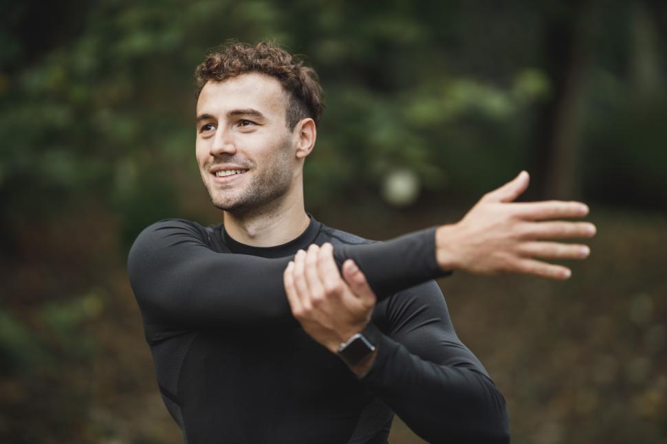 Free Image of Male athletic runner doing warm up exercise 