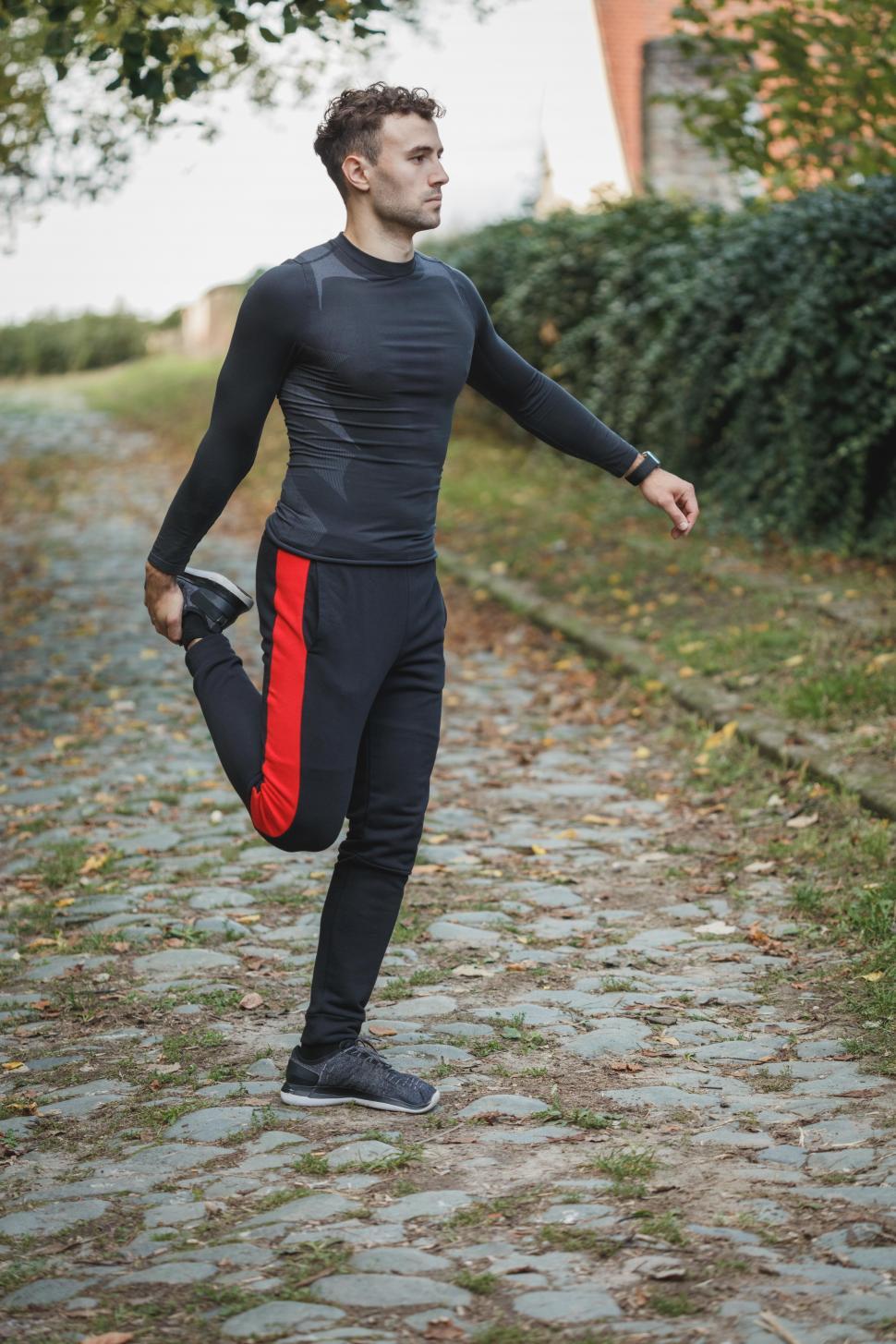 Free Image of Male athletic runner doing warm up exercise 
