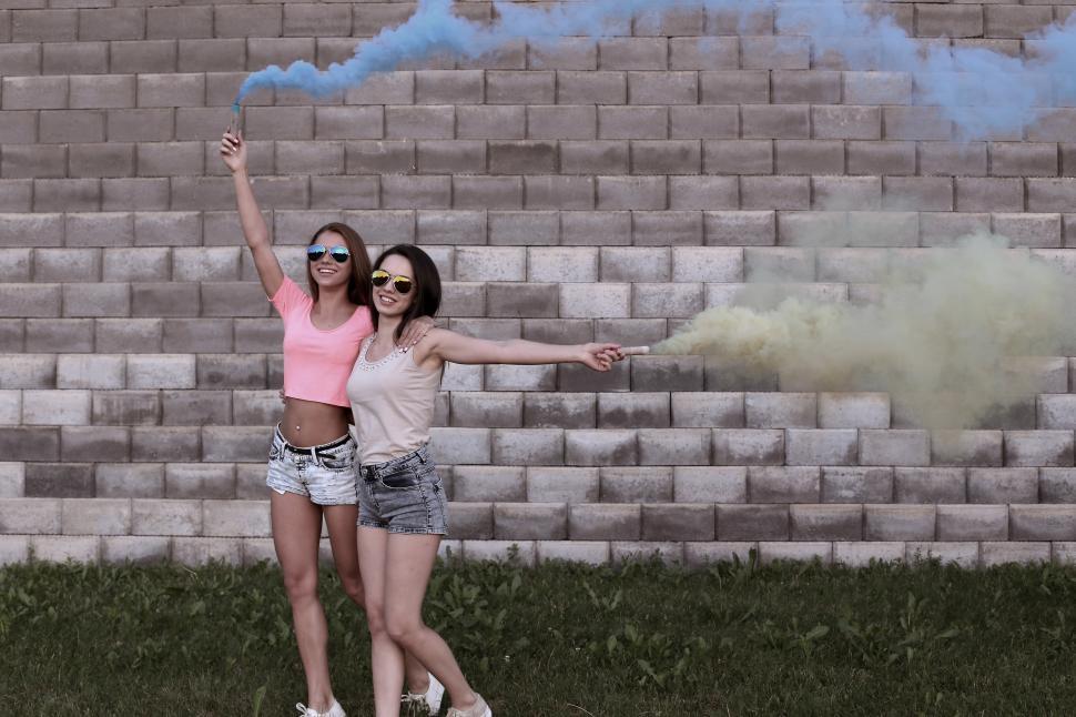 Free Image of Two Woman with Colorful Smoke Sticks 