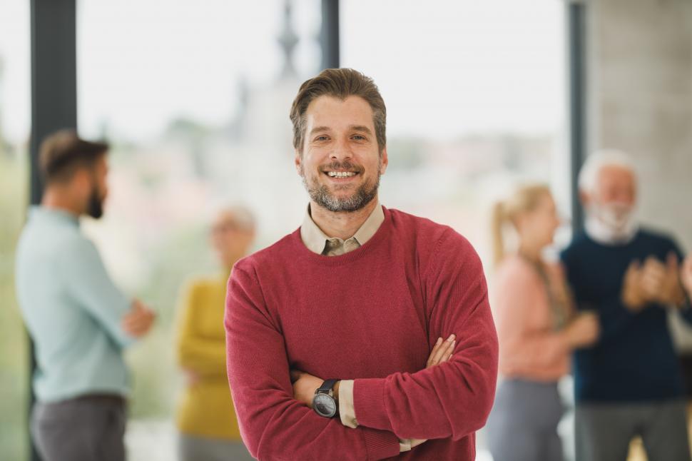 Free Image of Male office worker standing and posing confidently in office 