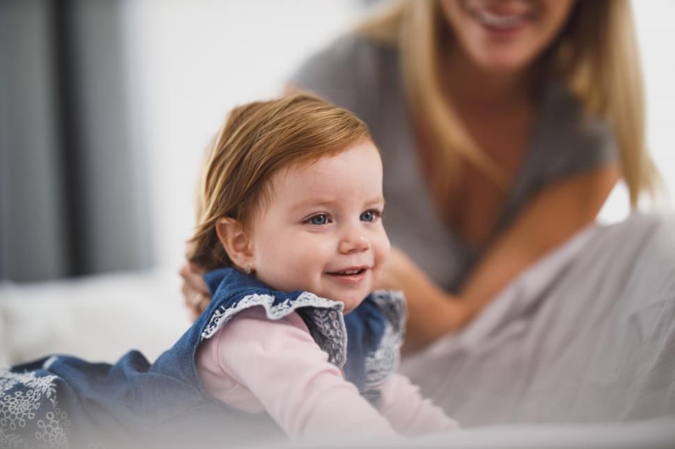Free Image of Cute little toddler girl playing on bed 
