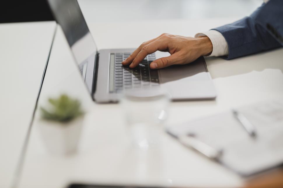 Free Image of Hand on laptop keyboard 