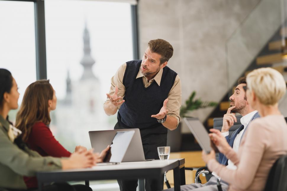 Free Image of Senior young male manager discussing a project with team members 