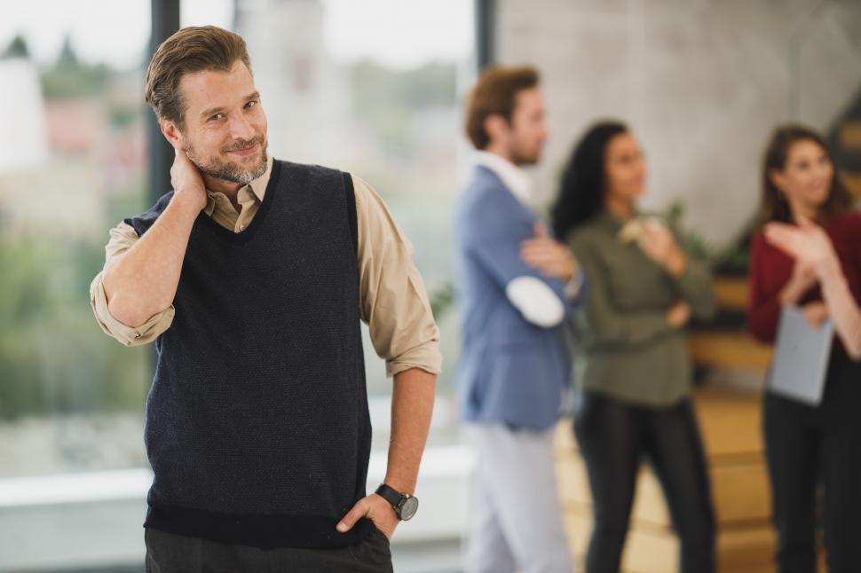 Free Image of Male office worker posing in office - looking uncomfortable 