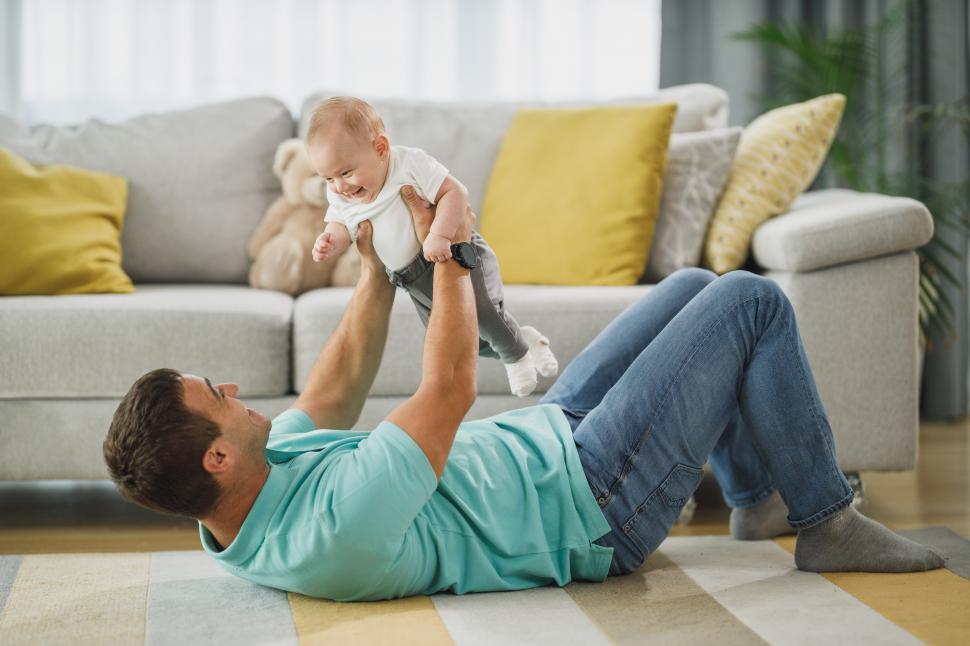 Free Image of Cheerful young dad and little son playing at home 