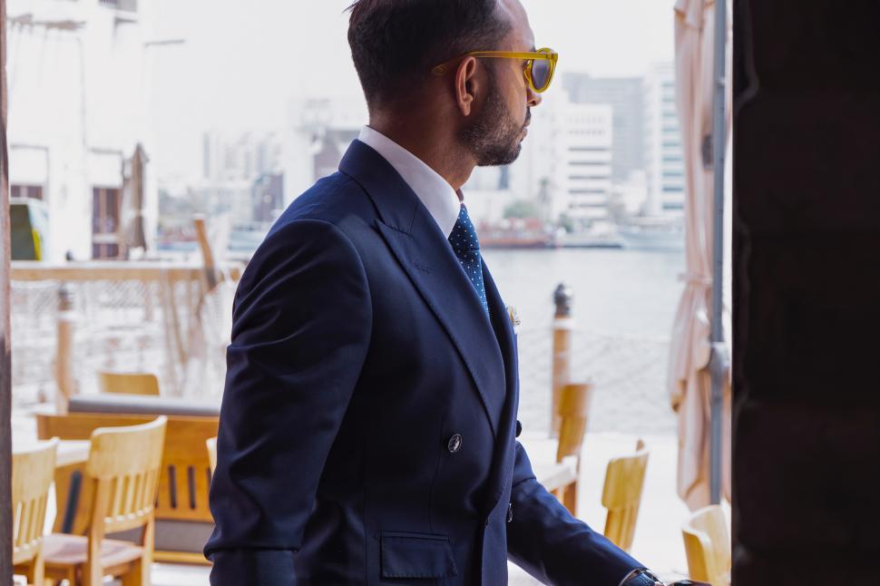 Free Image of Young man in suit standing in a restaurant 