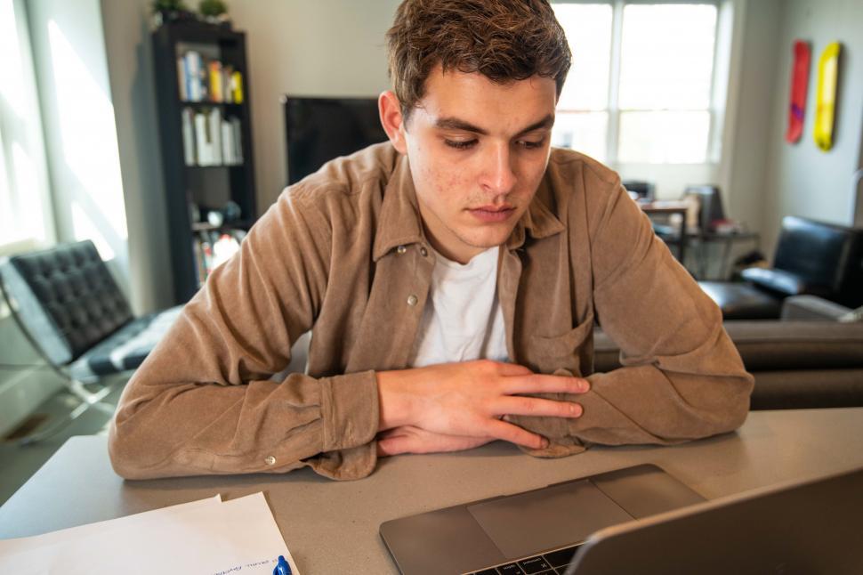 Free Image of Young man thinking with laptop 