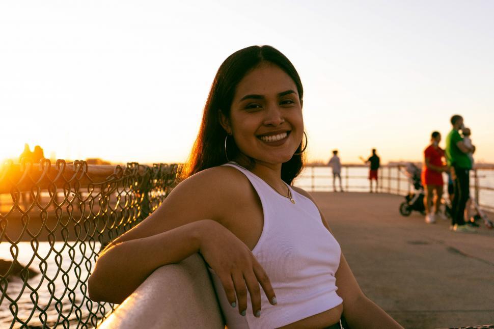 Free Image of Female fashion model sitting and posing on bench 