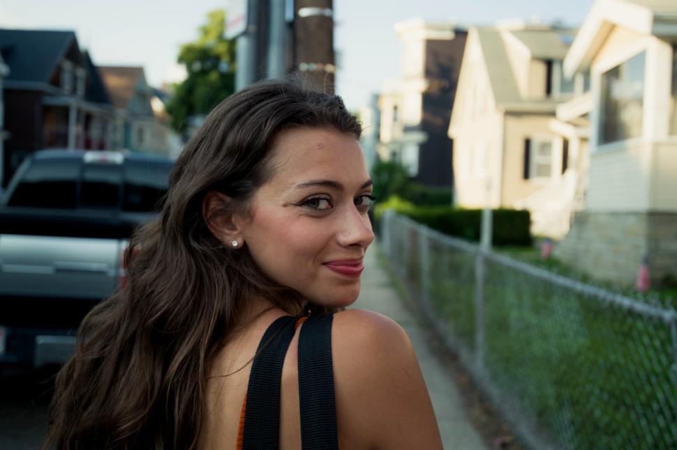 Free Image of Rear view of woman walking on the street - looking at camera 