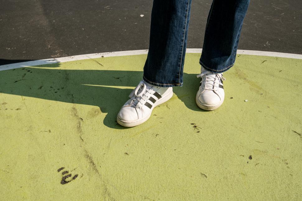 Free Image of Feet with white sneakers 