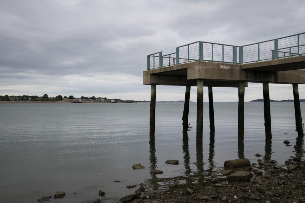 Free Image of Pier and ocean with cloudy sky 