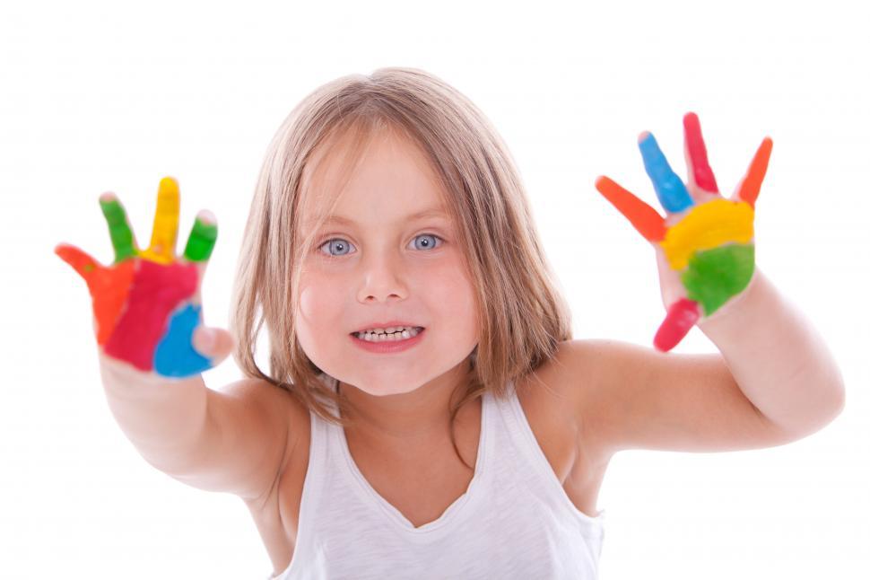 Free Image of Happy girl with paint on her hands 