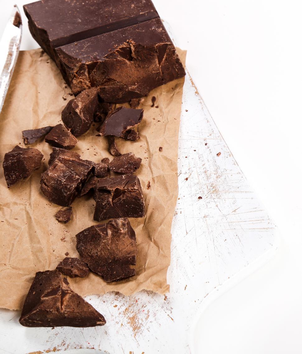 Free Image of Black chocolate chunked onto a table 