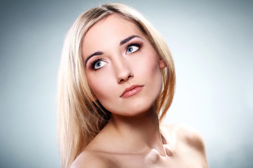 Free Image of Young woman looking off camera, head tilted 