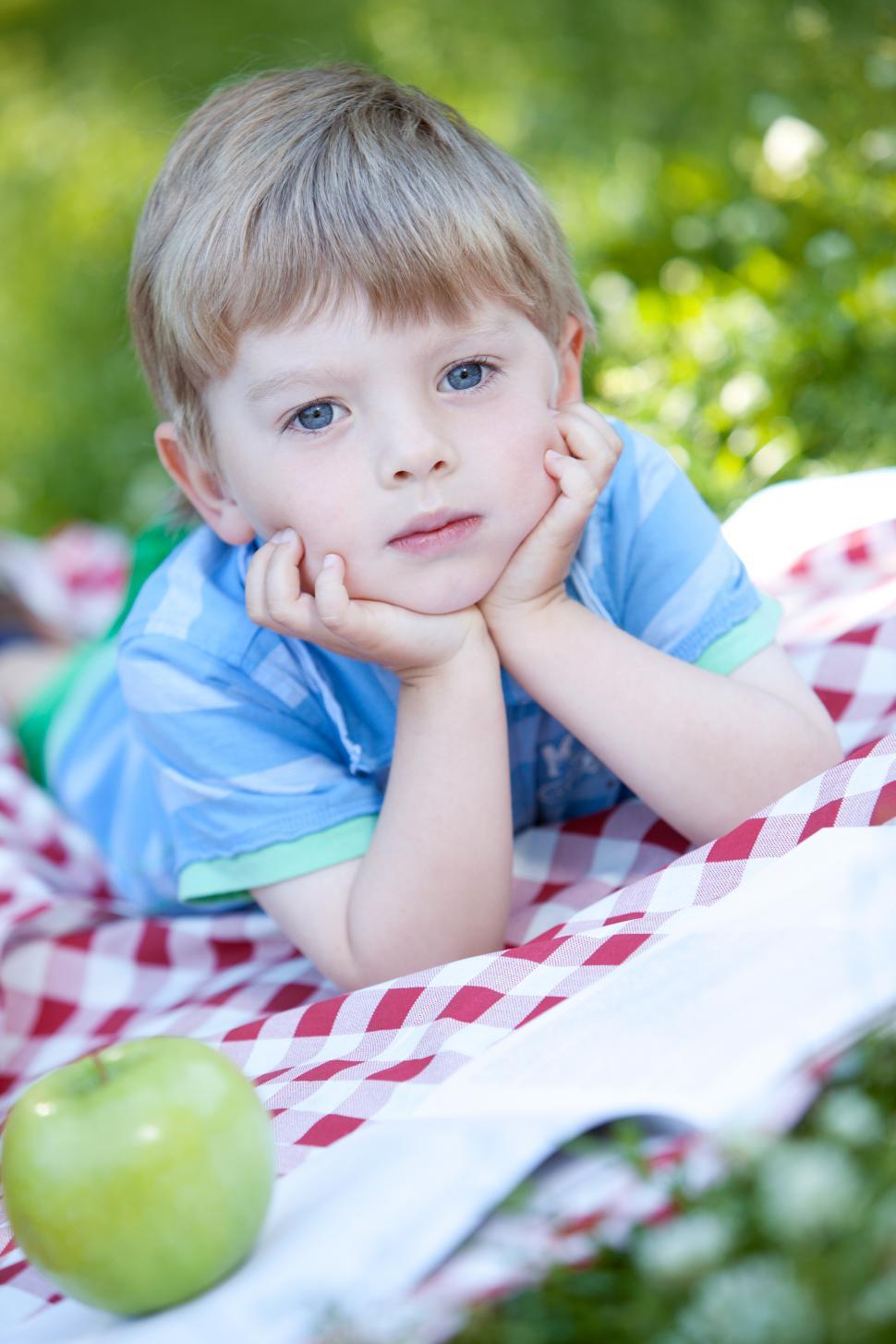 Free Image of Portrait of cute little boy with head in hands 