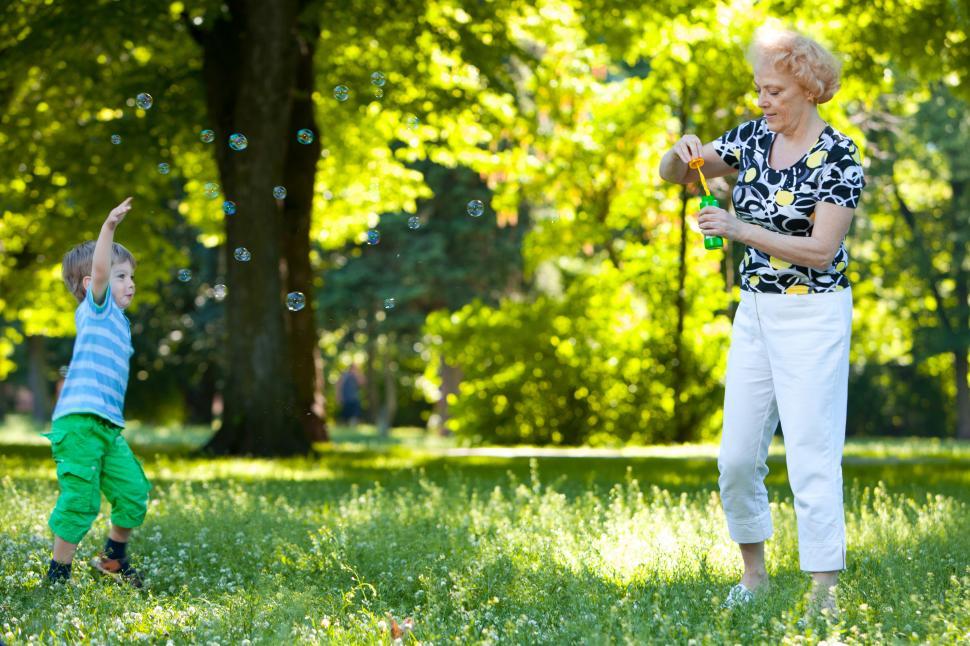 Free Image of Grandmother and her grandson blowing soap bubbles 