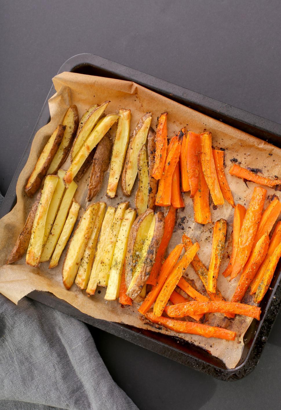 Free Image of French fries - potato and sweet potato on paper 