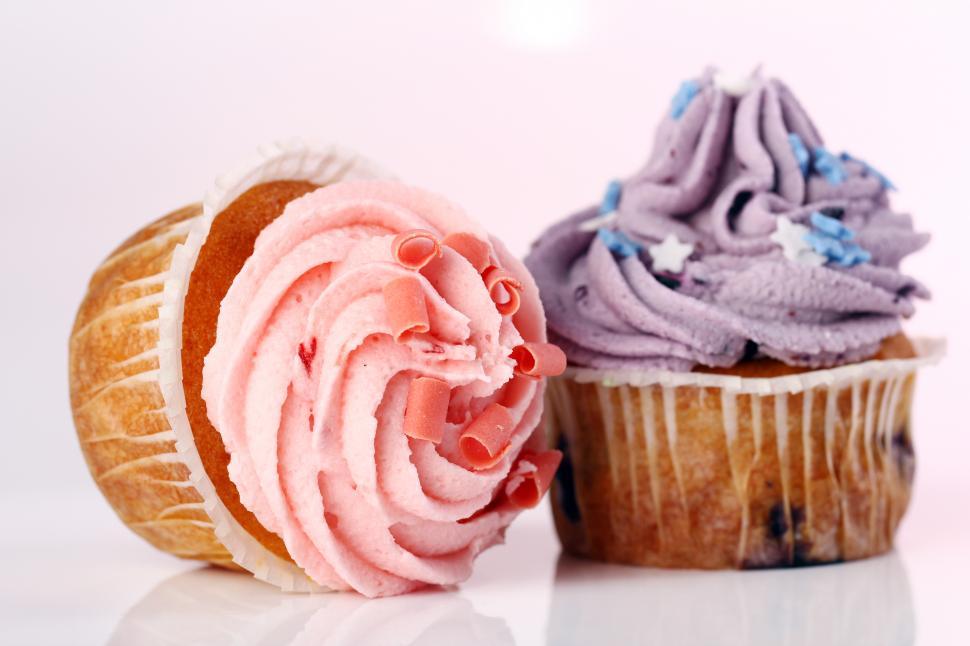 Free Image of Two holiday cupcakes with colorful frosting 
