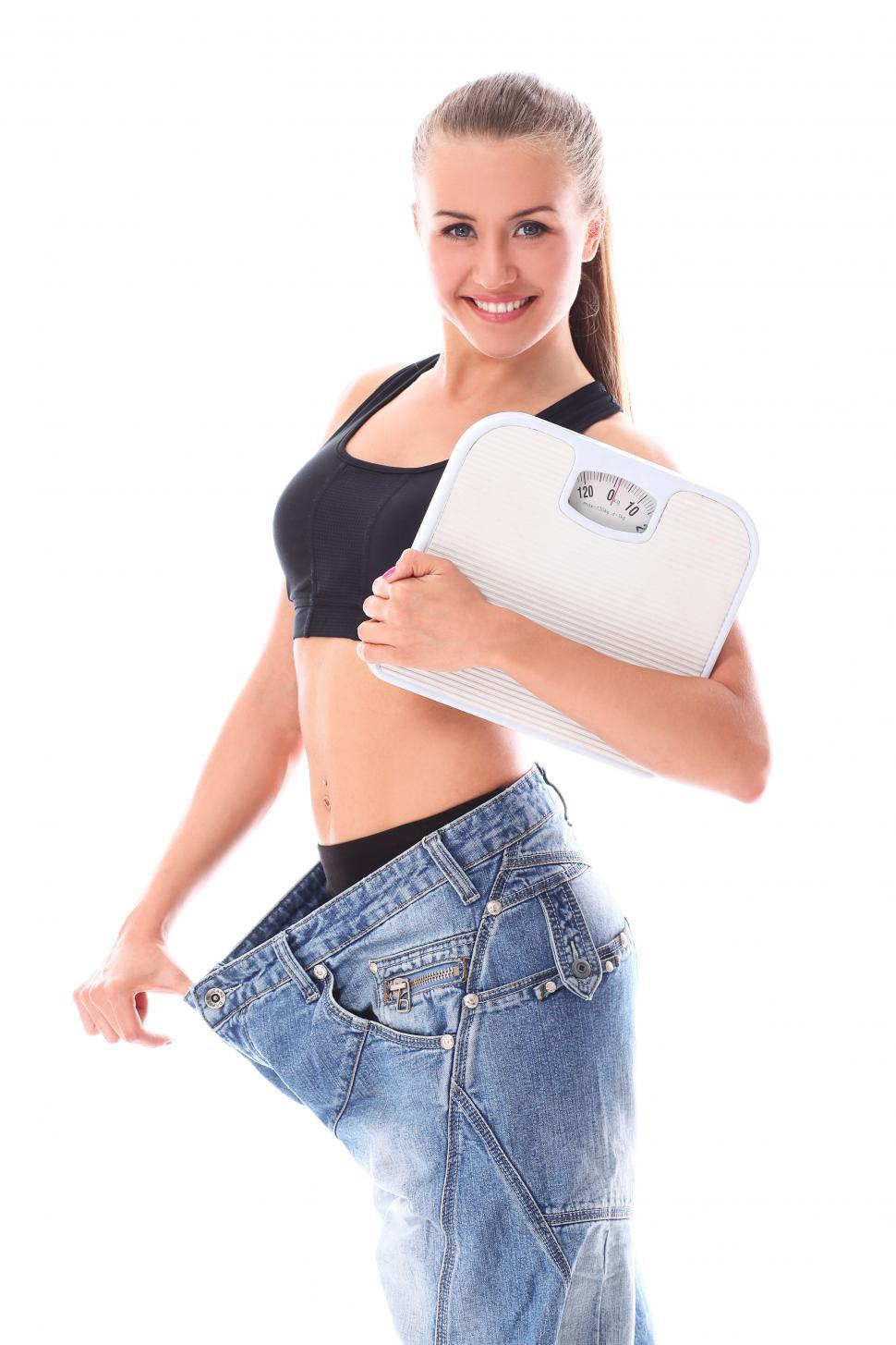 Free Image of Woman wearing old jeans after weight loss 