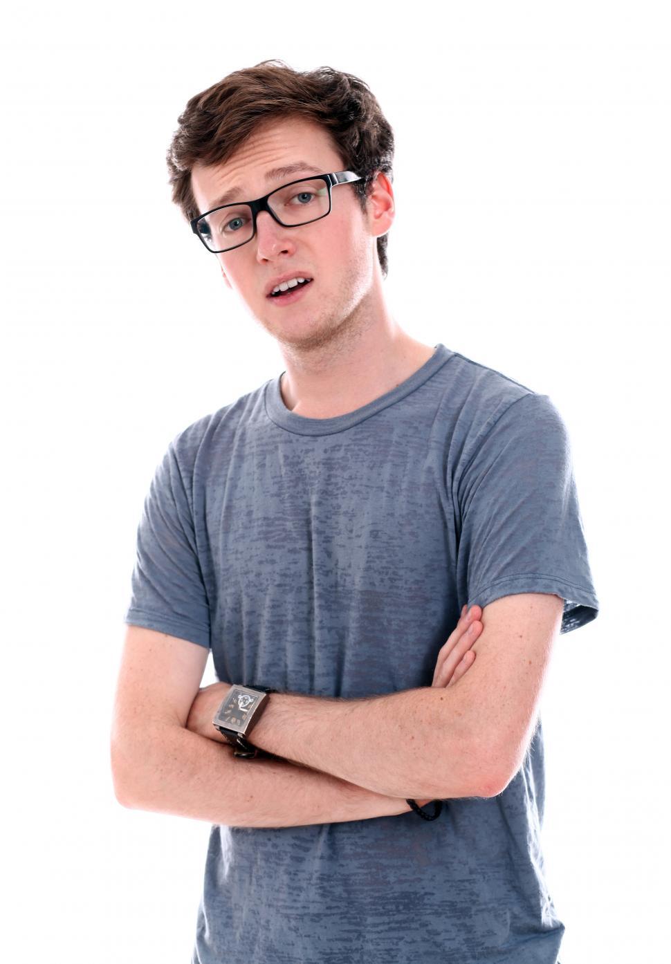 Free Image of Young guy in t-shirt with arms crossed in front of him 
